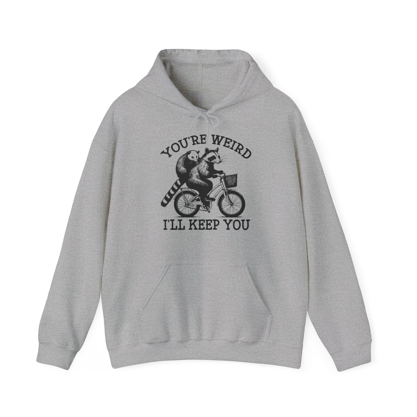 Front view of a gray hoodie featuring the text "You're Weird, I'll Keep You" with a cartoon illustration of two raccoons riding a bicycle. Part of the Vivid Divergence Sensory Friendly Unisex Hoodie Range.