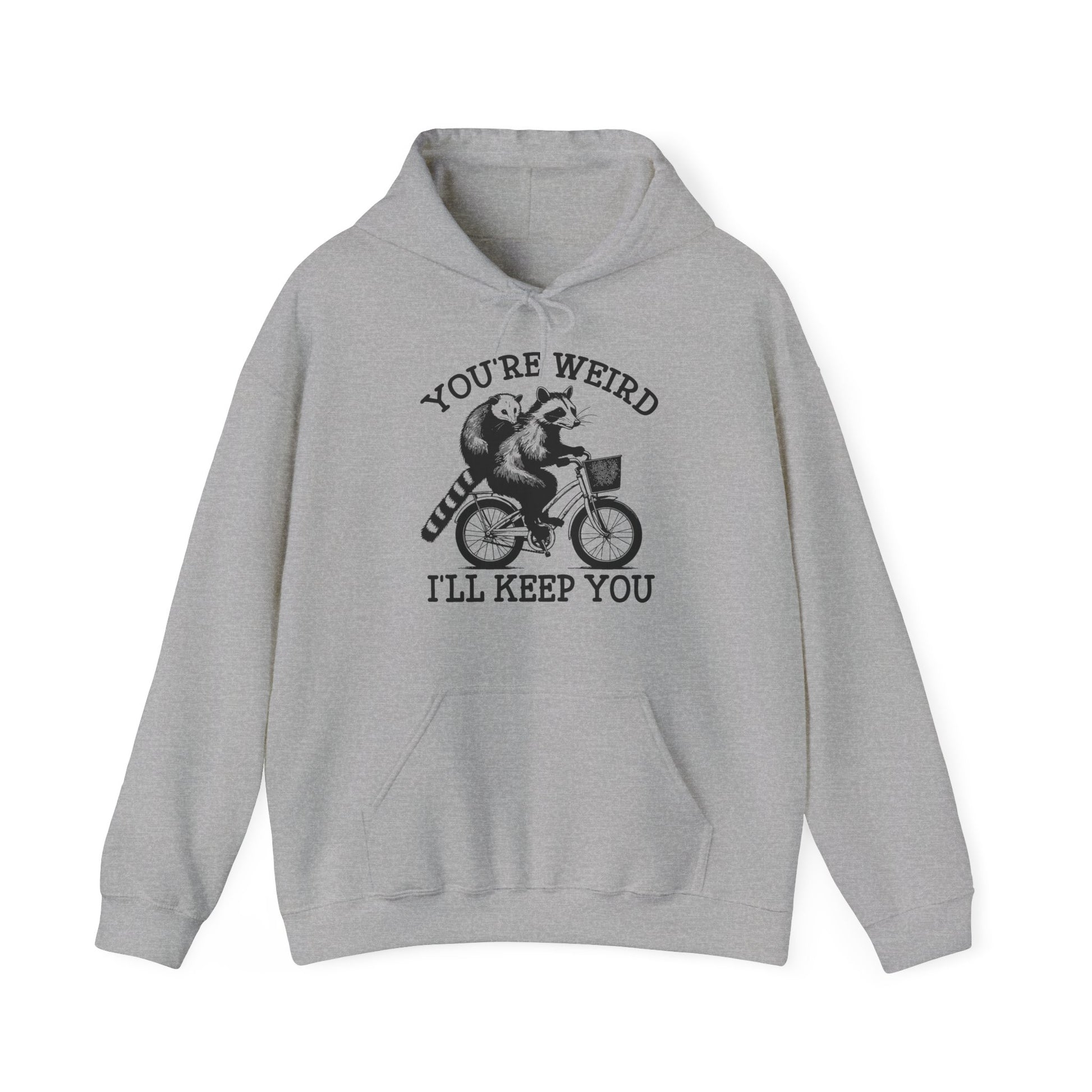 Front view of a gray hoodie featuring the text "You're Weird, I'll Keep You" with a cartoon illustration of two raccoons riding a bicycle. Part of the Vivid Divergence Sensory Friendly Unisex Hoodie Range.