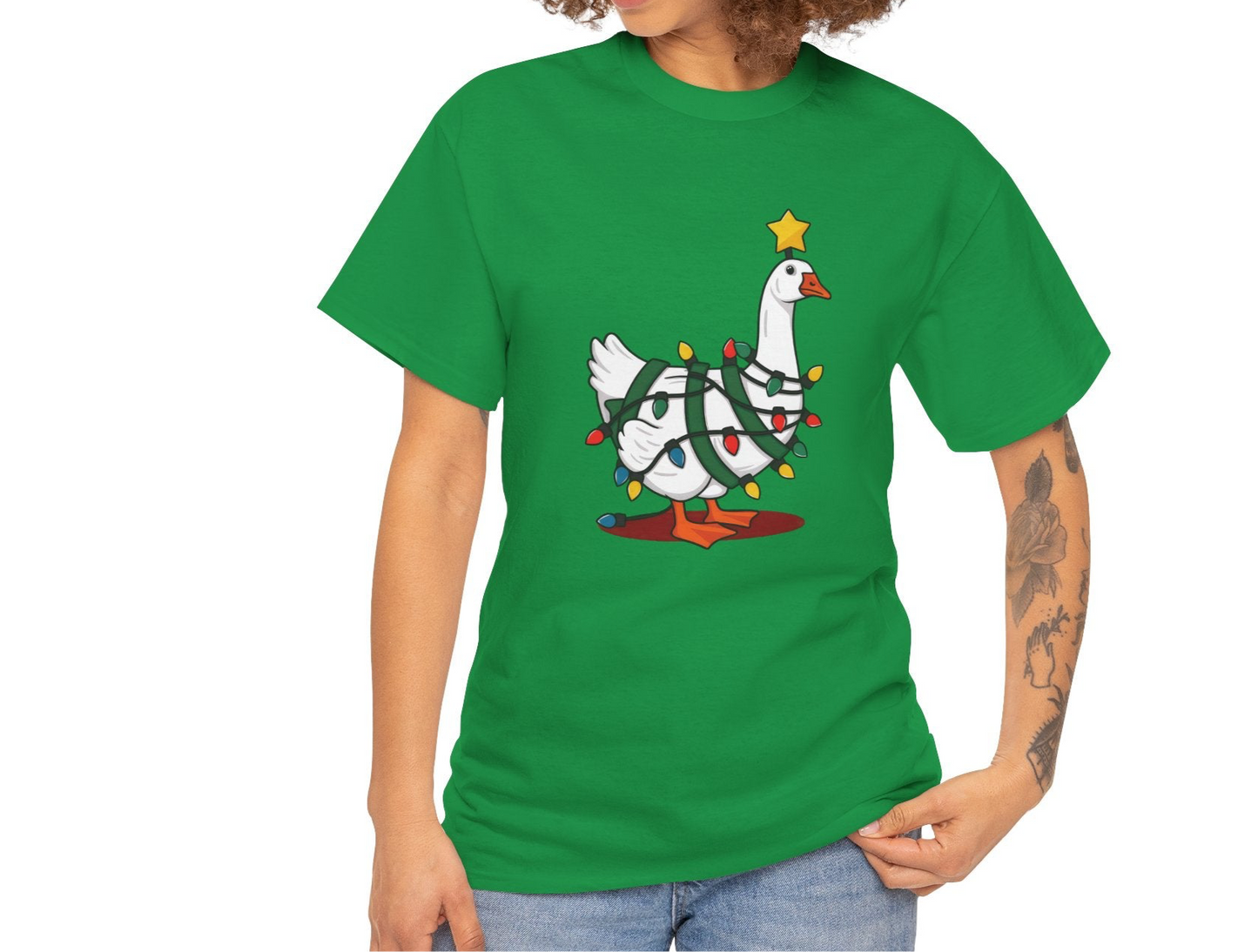 Model wearing a green T-shirt featuring a festive illustration of a goose wearing a Santa hat and stringing Christmas lights, with the text "Goose on the Loose." Part of the Vivid Divergence Sensory Friendly Unisex Tees Range.