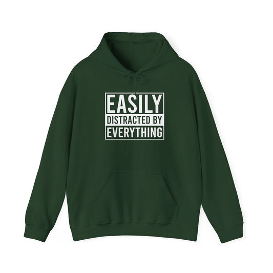 Front view of a green hoodie with the text "Easily Distracted by Everything" in bold white lettering. Part of the Vivid Divergence Sensory Friendly Unisex Hoodie Range.
