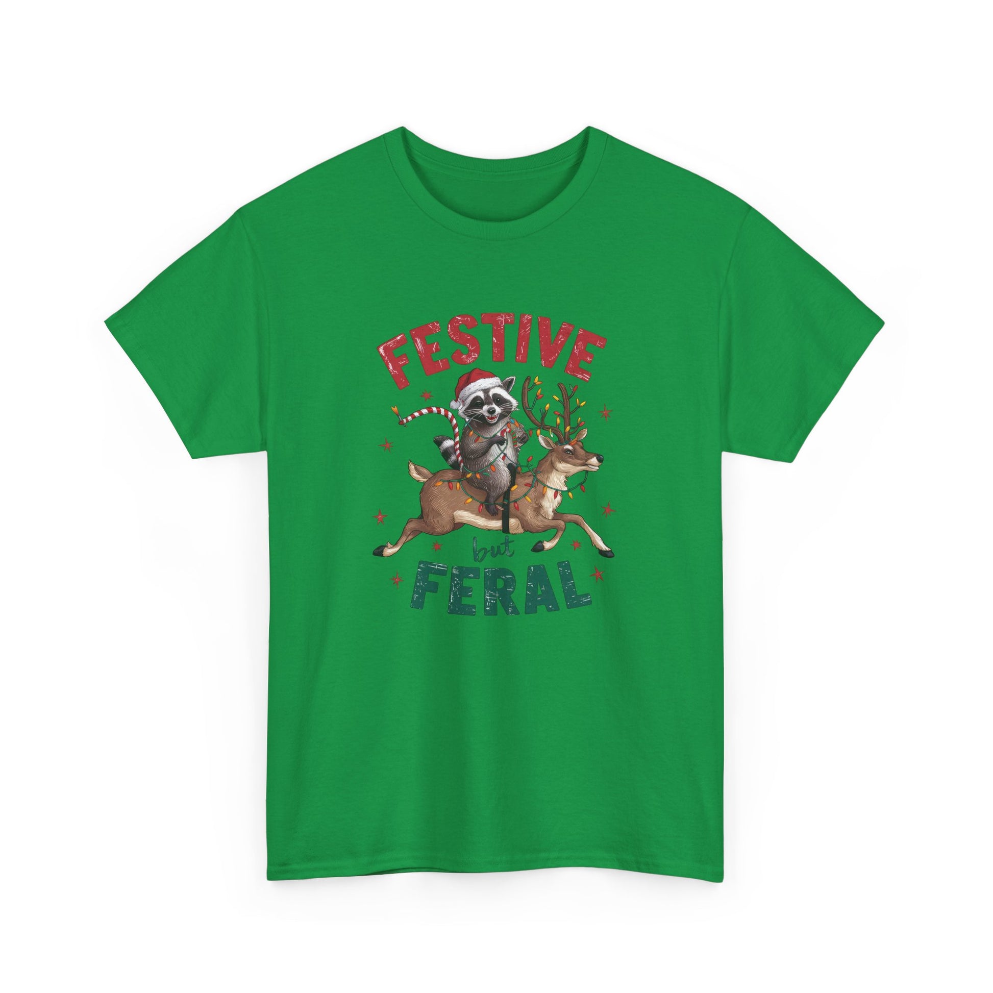 Front view of a green T-shirt featuring a festive illustration of a raccoon (trash panda) holding Christmas lights and the text "Festive but Feral." Part of the Vivid Divergence Sensory Friendly Unisex Tees Range.
