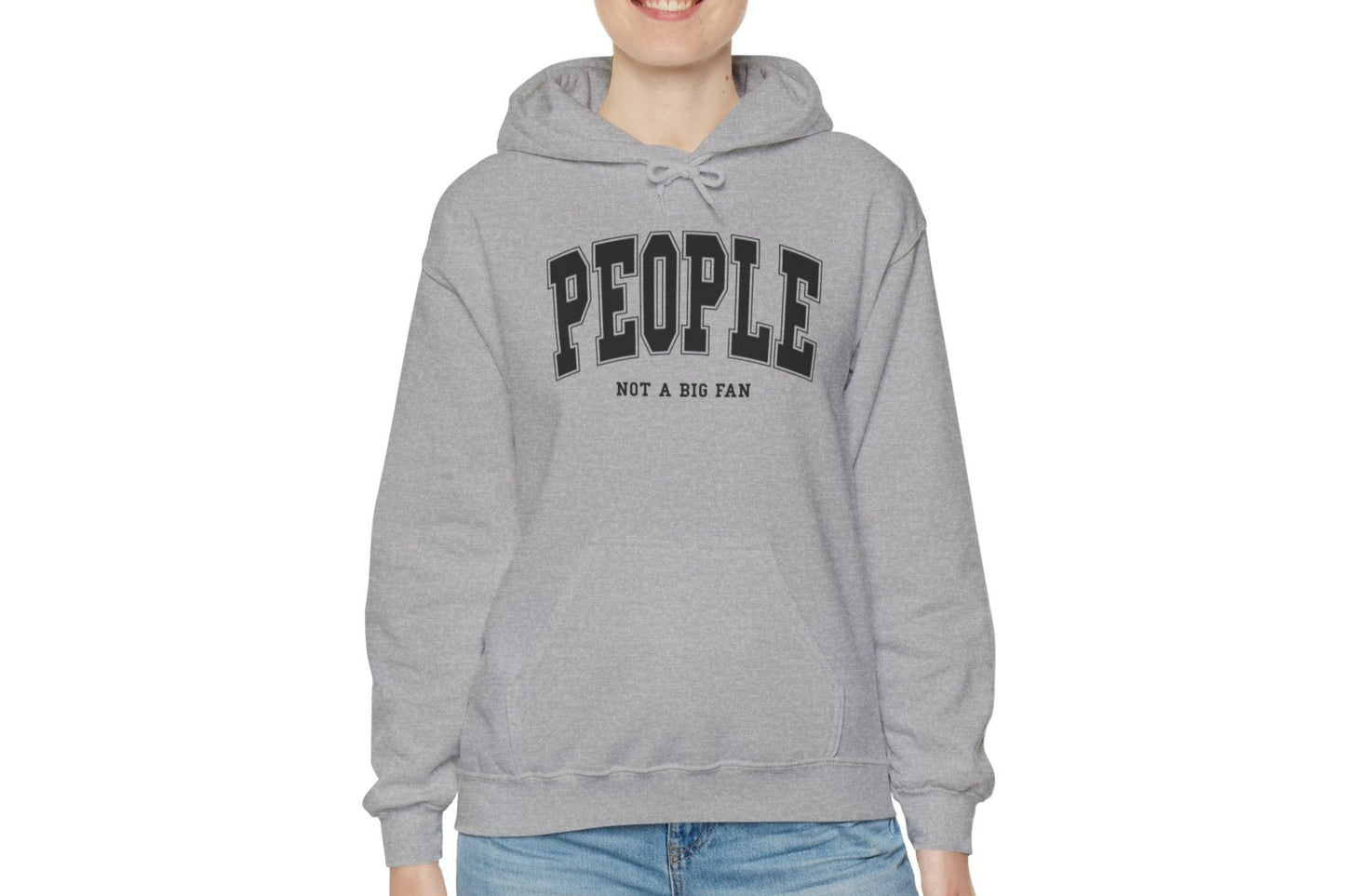 Model wearing a grey hoodie featuring the text "People, Not a Big Fan" in bold collegiate-style white lettering. Part of the Vivid Divergence Sensory Friendly Unisex Hoodie Range.
