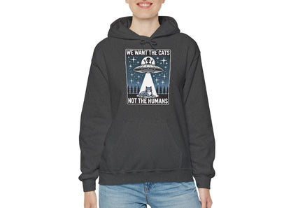 Model wearing a grey hoodie featuring the text "We Want the Cats, Not the Humans" with an illustration of a UFO beaming up cats. Part of the Vivid Divergence Sensory Friendly Unisex Hoodie Range.