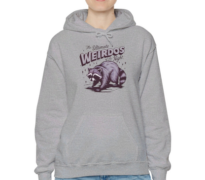 Model wearing a grey hoodie featuring the text "The Ultimate Weirdos of the Night" with a cartoon illustration of a raccoon and an opossum. Part of the Vivid Divergence Sensory Friendly Unisex Hoodie Range.