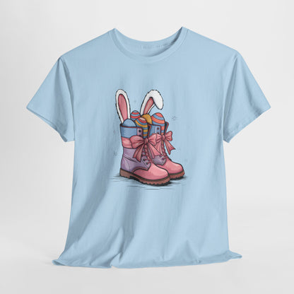 Light Blue T-shirt hanging, displaying an Easter cowgirl boots design with bunny ears and eggs, a cute springtime look. Hop into the season in style and shop Easter shirts online today!