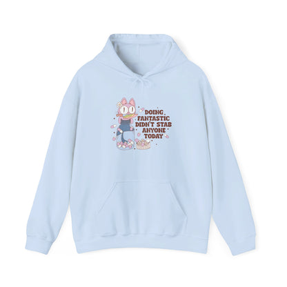 Front view of a light blue hoodie featuring the text "Doing Fantastic, Didn’t Stab Anyone Today" and a cartoon illustration of a raccoon holding a knife. Part of the Vivid Divergence Sensory Friendly Unisex Hoodie Range.