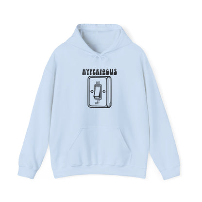 Front view of a light blue hoodie featuring the text "Hyperfocus" and an illustration of a toggle switch turned on. Part of the Vivid Divergence Sensory Friendly Unisex Hoodie Range.