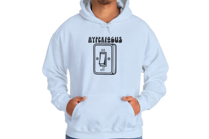 Model wearing a light blue hoodie featuring the text "Hyperfocus" and an illustration of a toggle switch turned on. Part of the Vivid Divergence Sensory Friendly Unisex Hoodie Range.