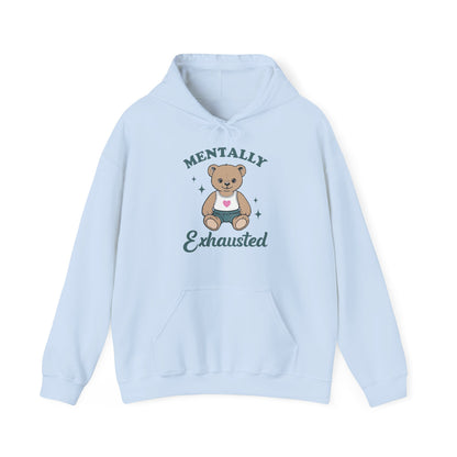 Front view of a light blue hoodie featuring a cute teddy bear wearing an apron with the text "Mentally Exhausted." Part of the Vivid Divergence Sensory Friendly Unisex Hoodie Range.