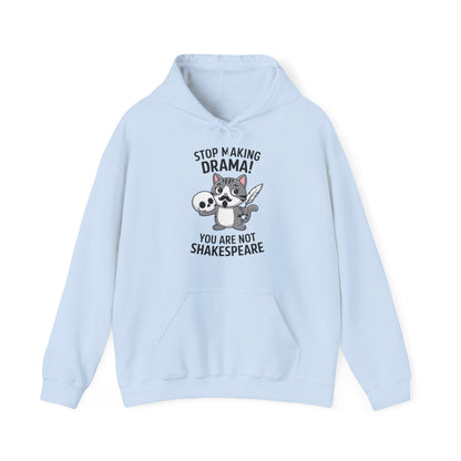 Front view of a light blue hoodie featuring a cartoon cat holding a skull with the text "Stop Making Drama! You Are Not Shakespeare." Part of the Vivid Divergence Sensory Friendly Unisex Hoodie Range.