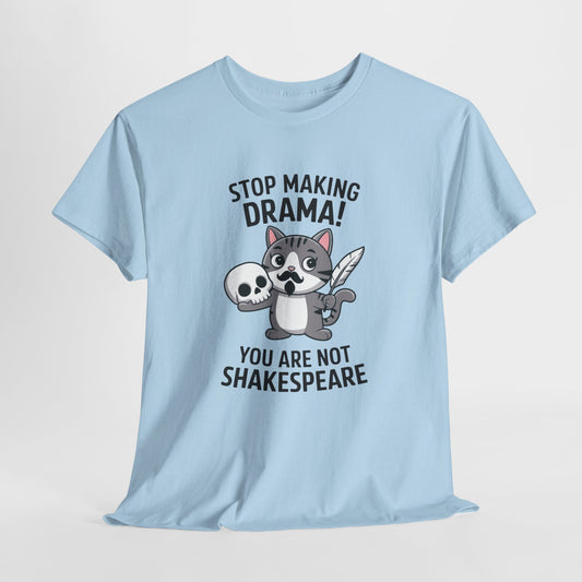 Hanging front view of a light blue T-shirt featuring a cute cat holding a skull and text that reads "Stop Making Drama! You Are Not Shakespeare." Part of the Vivid Divergence Sensory Friendly Unisex Tees Range.