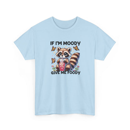 Front view of a light blue T-shirt featuring a raccoon graphic with food and the text "If I'm Moody, Give Me Foody." Part of the Vivid Divergence Sensory Friendly Unisex Tees Range.