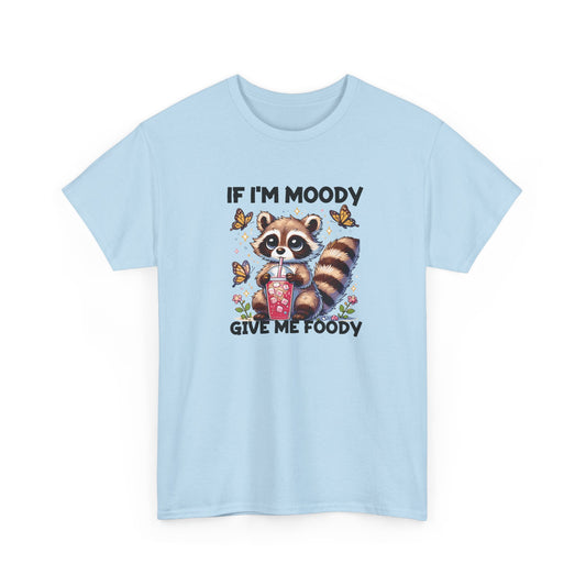 Front view of a light blue T-shirt featuring a raccoon graphic with food and the text "If I'm Moody, Give Me Foody." Part of the Vivid Divergence Sensory Friendly Unisex Tees Range.