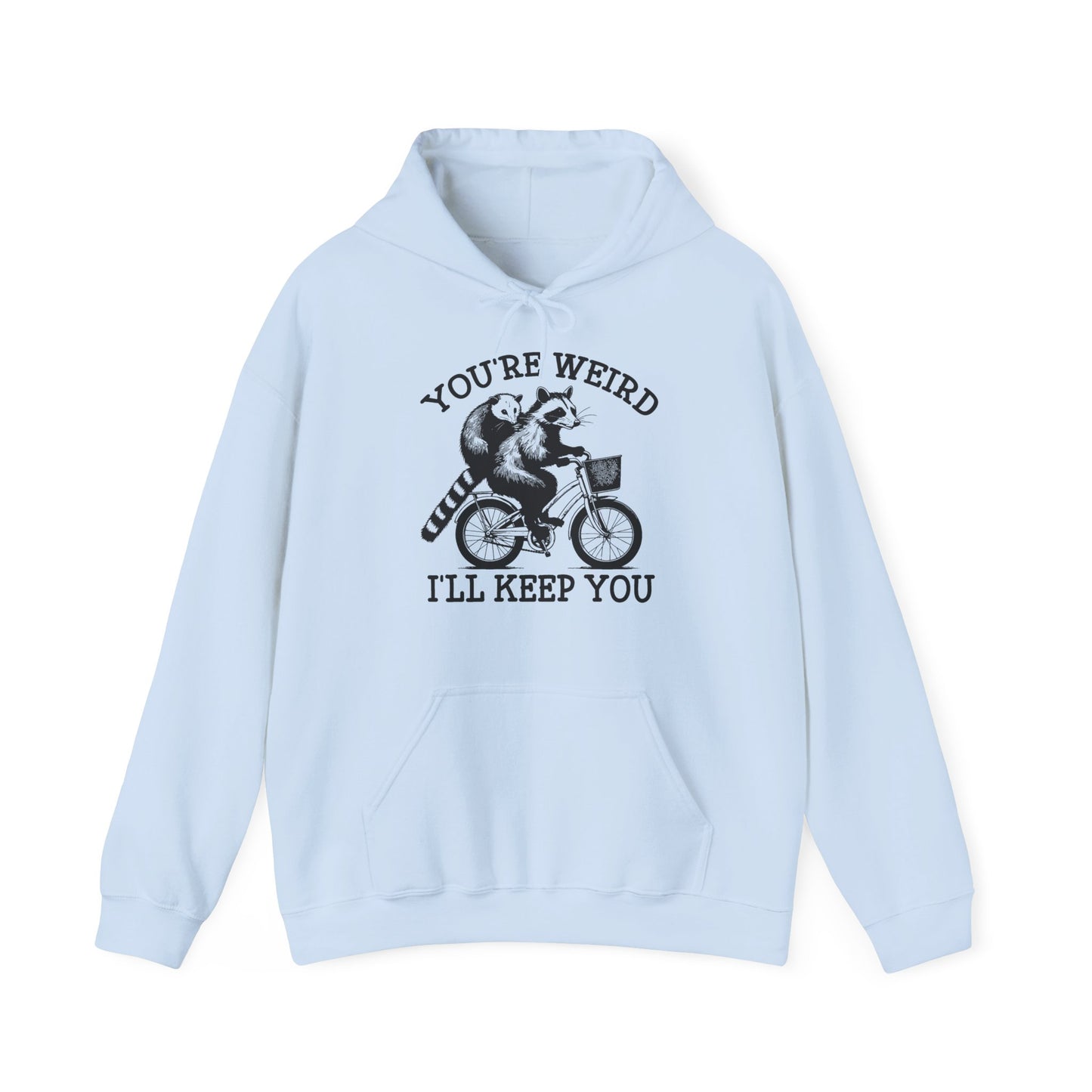 Front view of a light blue hoodie featuring the text "You're Weird, I'll Keep You" with a cartoon illustration of two raccoons riding a bicycle. Part of the Vivid Divergence Sensory Friendly Unisex Hoodie Range.