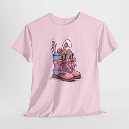 Light Pink T-shirt hanging, decorated with Easter cowgirl boots, bunny ears, and colorful eggs, a cute and trendy spring tee. Hop into the season in style and shop Easter shirts online today!