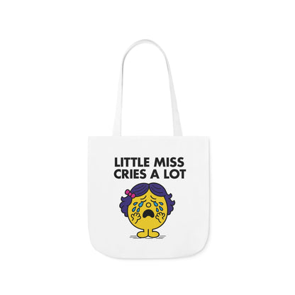 Front view of white canvas tote bag featuring yellow character with blue pigtails and teary eyes, mid-sob under the text "Little Miss Cries A Lot." Part of the Vivid Divergence Little Miss Meme Collection!
