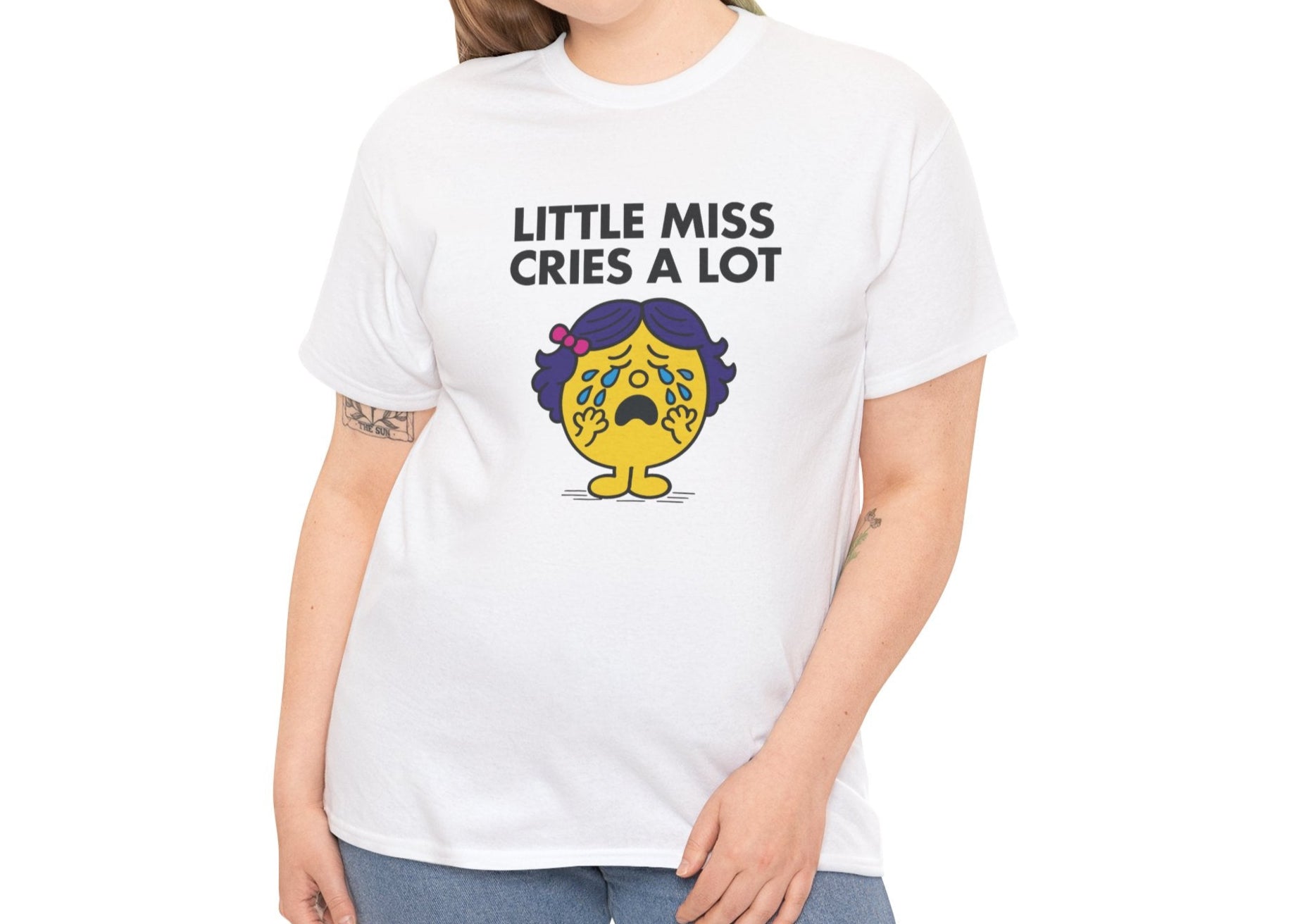 Person wearing the Little Miss Cries A Lot T-shirt paired with jeans. Part of the Little Miss Meme Character Collection. A Vivid Divergence Sensory Friendly Unisex Tee.
