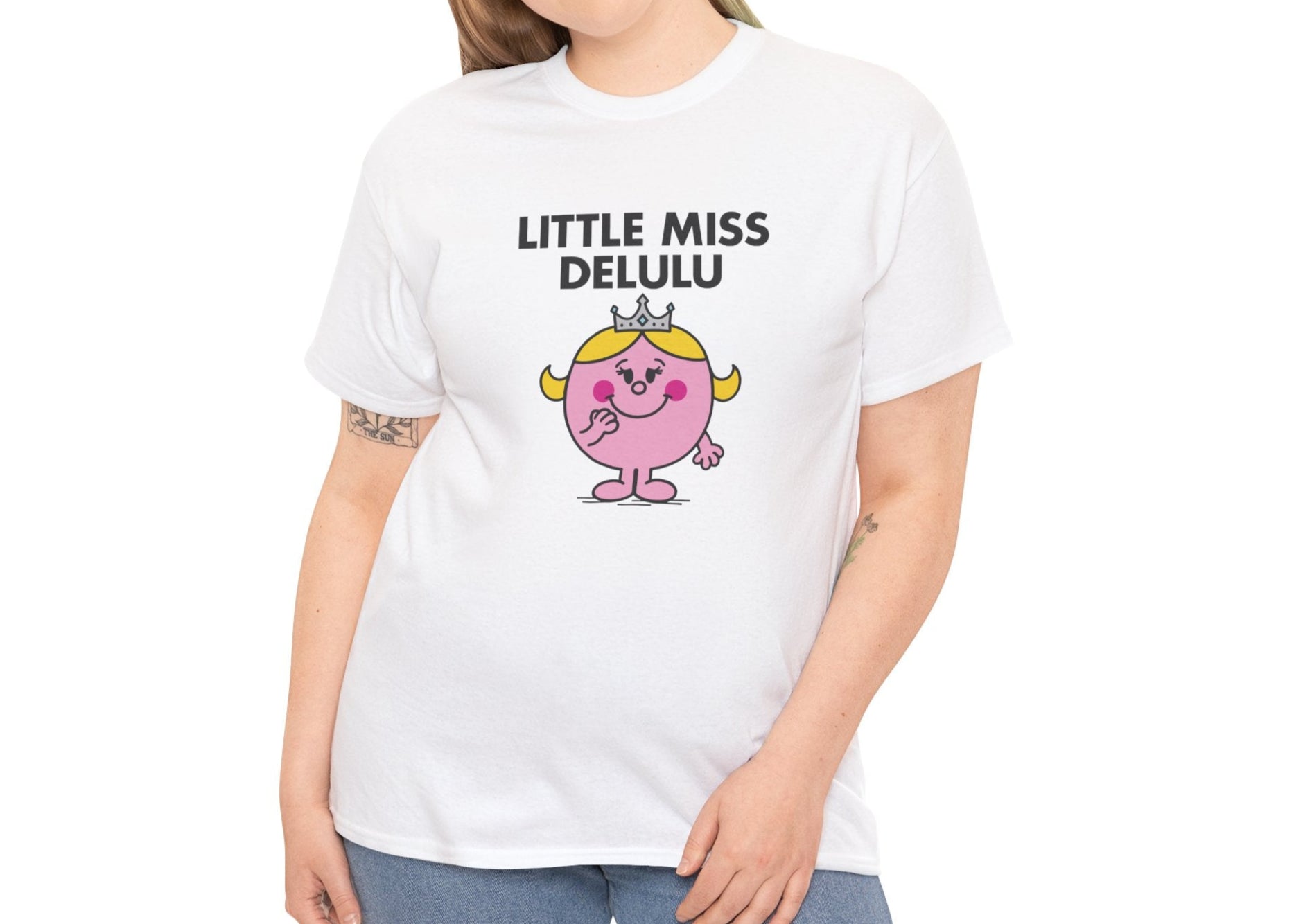 Person wearing the Little Miss Delulu T-shirt with light-wash jeans. Part of the Little Miss Meme Character Collection. A Vivid Divergence Sensory Friendly Unisex Tee.
