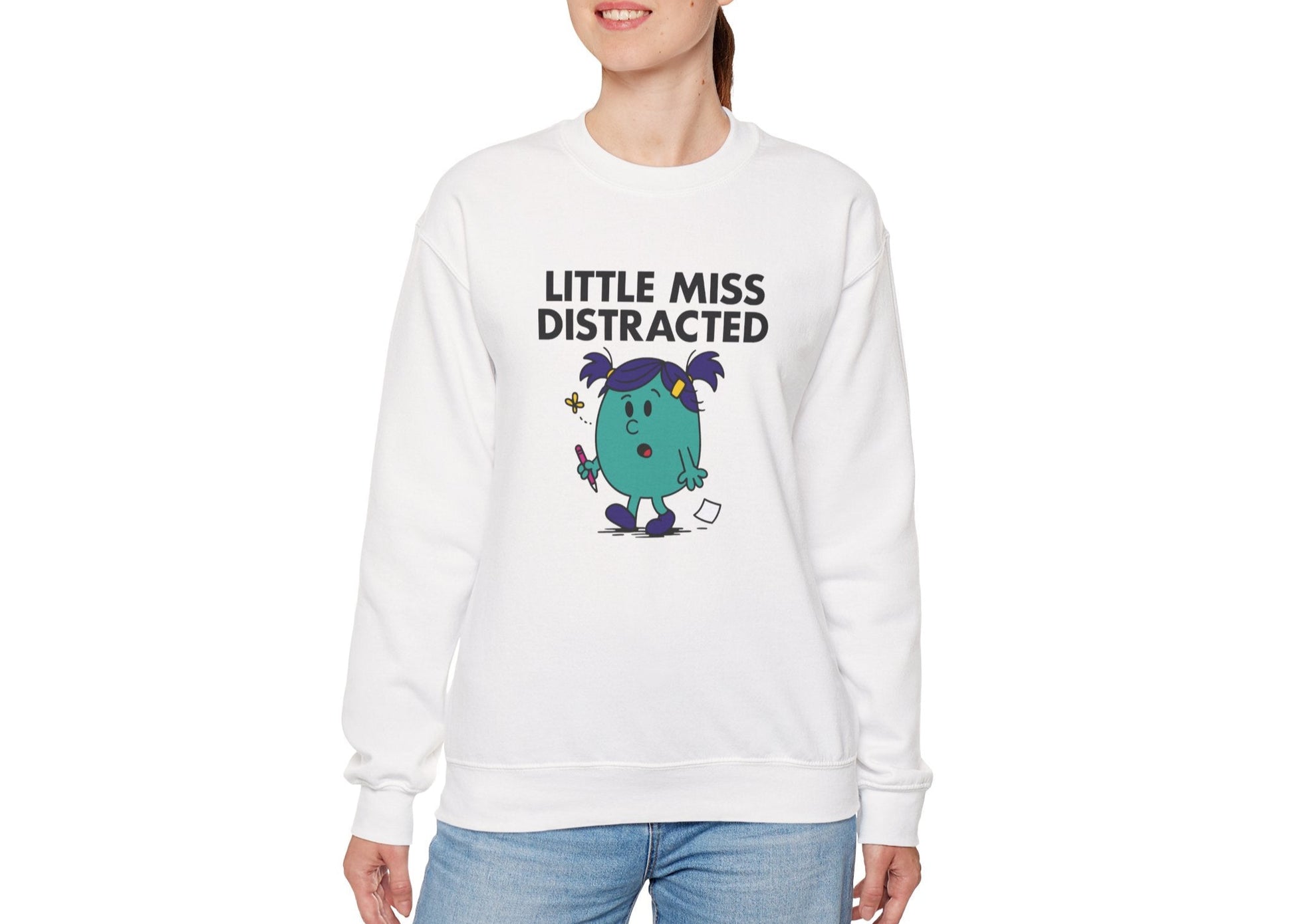 Person wearing the Little Miss Distracted sweatshirt with casual jeans. Part of the Little Miss Meme Character Collection. A Vivid Divergence Sensory Friendly Sweater Jumper.
