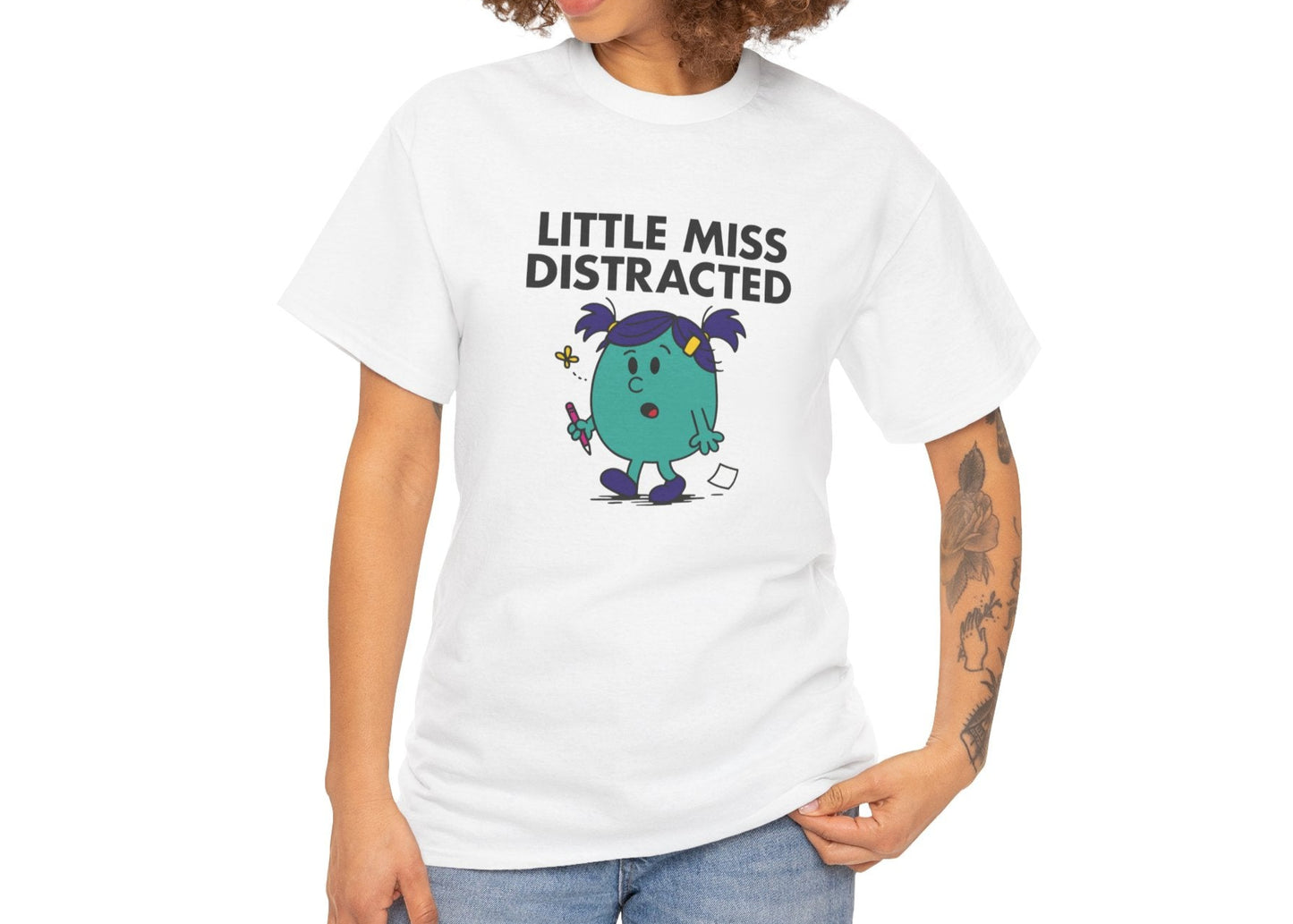 Person wearing the Little Miss Distracted T-shirt with relaxed jeans. Part of the Little Miss Meme Character Collection. A Vivid Divergence Sensory Friendly Unisex Tee.
