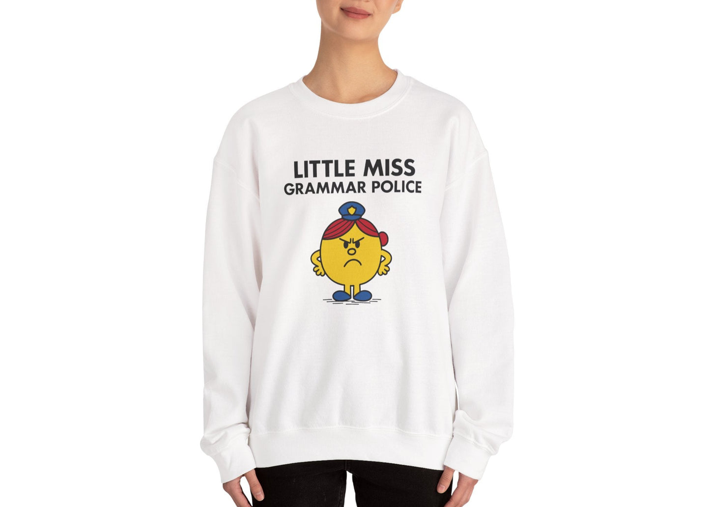 Person wearing the Little Miss Grammar Police sweatshirt in a standing pose. Part of the Little Miss Meme Character Collection. A Vivid Divergence Sensory Friendly Sweater Jumper.
