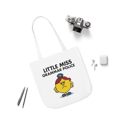 Flat lay of tote bag featuring Little Miss Grammar Police surrounded by pens and accessories. She brought a red pen to brunch. Part of the Vivid Divergence Little Miss Meme Collection!
