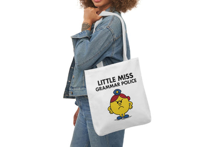 Woman in denim modeling the Little Miss Grammar Police tote over her shoulder. She corrects people in real life and online. Part of the Vivid Divergence Little Miss Meme Collection!
