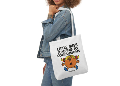Woman in denim modeling the Little Miss Jumping To Conclusions tote bag over her shoulder. She’s bracing for a plot twist that isn’t coming. Part of the Vivid Divergence Little Miss Meme Collection!
