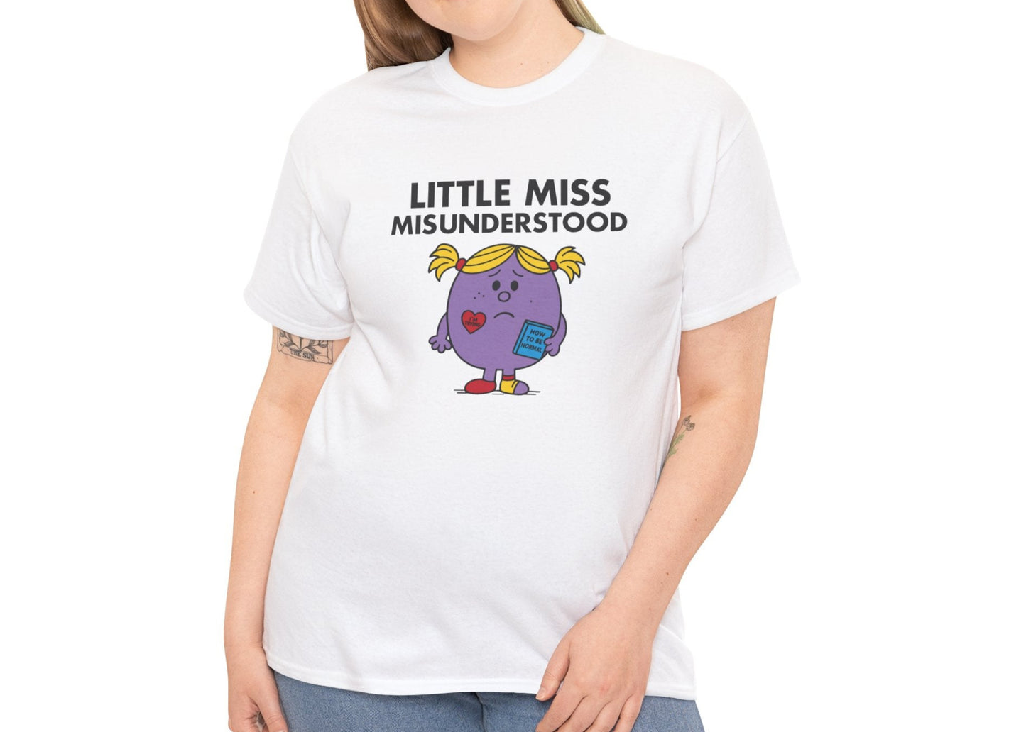 Person wearing the Little Miss Misunderstood T-shirt styled casually with jeans. Part of the Little Miss Meme Character Collection. A Vivid Divergence Sensory Friendly Unisex Tee.
