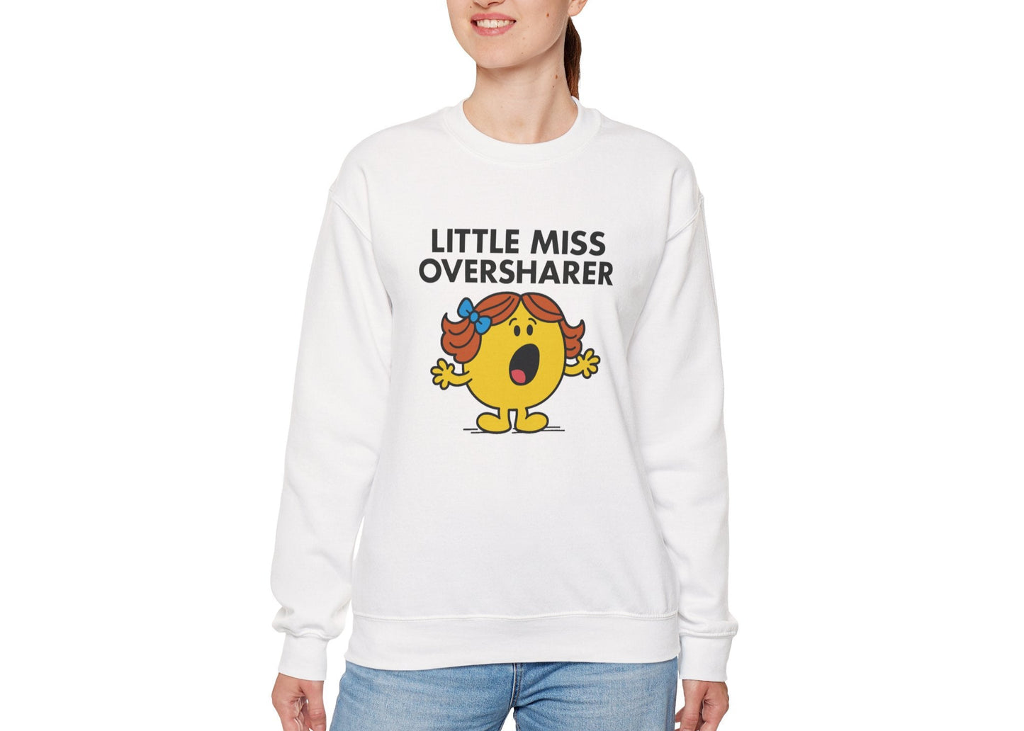 Person wearing the Little Miss Oversharer sweatshirt with casual jeans. Part of the Little Miss Meme Character Collection. A Vivid Divergence Sensory Friendly Sweater Jumper.
