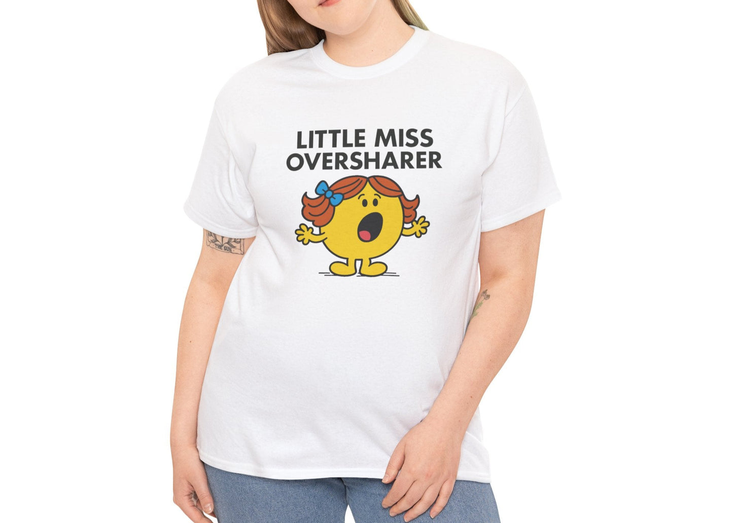 Person wearing the Little Miss Oversharer T-shirt with blue jeans. Part of the Little Miss Meme Character Collection. A Vivid Divergence Sensory Friendly Unisex Tee.
