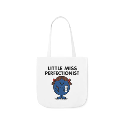  Front view of white canvas tote bag featuring blue character with red bows and a tight-lipped smile under the text "Little Miss Perfectionist." She’s one typo away from unraveling. Part of the Vivid Divergence Little Miss Meme Collection!
