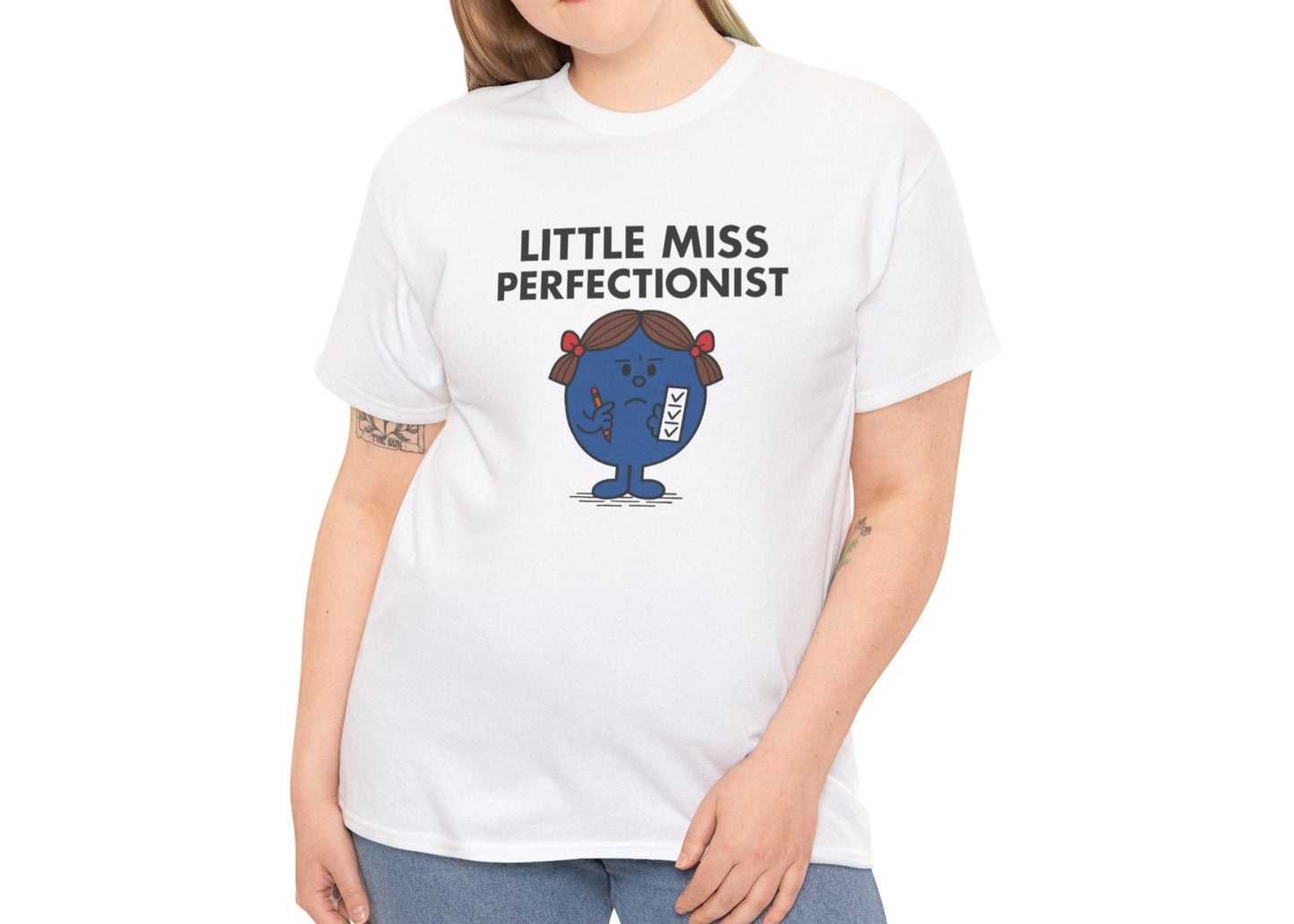 Person wearing the Little Miss Perfectionist T-shirt with jeans. Part of the Little Miss Meme Character Collection. A Vivid Divergence Sensory Friendly Unisex Tee.
