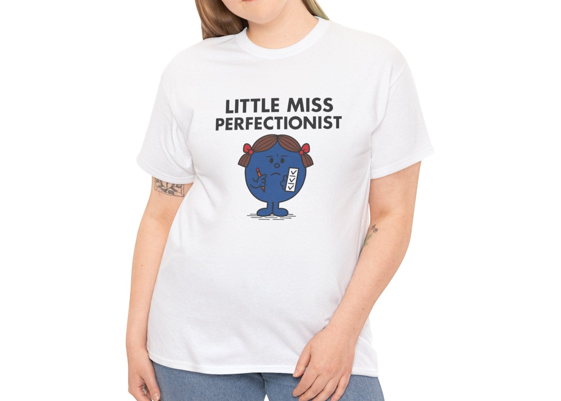 Person wearing the Little Miss Perfectionist T-shirt with jeans. Part of the Little Miss Meme Character Collection. A Vivid Divergence Sensory Friendly Unisex Tee.

