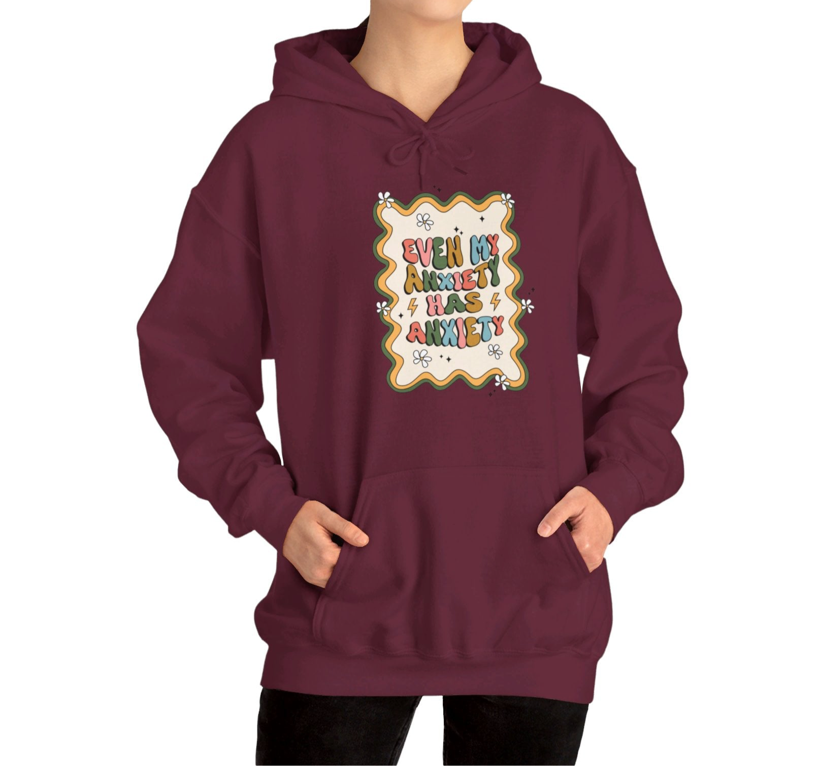 Model wearing a maroon hoodie with the text "Even My Anxiety Has Anxiety" surrounded by a decorative frame design. Part of the Vivid Divergence Sensory Friendly Unisex Hoodie Range.
