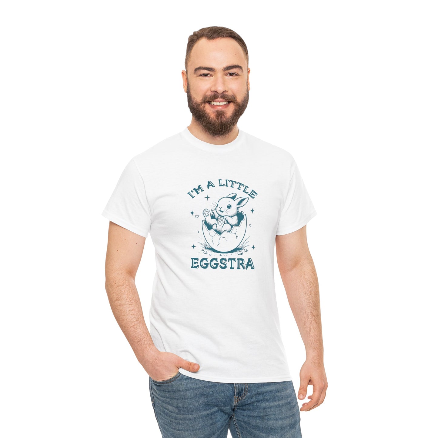 Man wearing a white Easter T-shirt featuring a playful bunny and "I'm A Little Eggstra" text, perfect for adding fun to Easter celebrations. Hop into the season in style and shop Easter shirts online today!