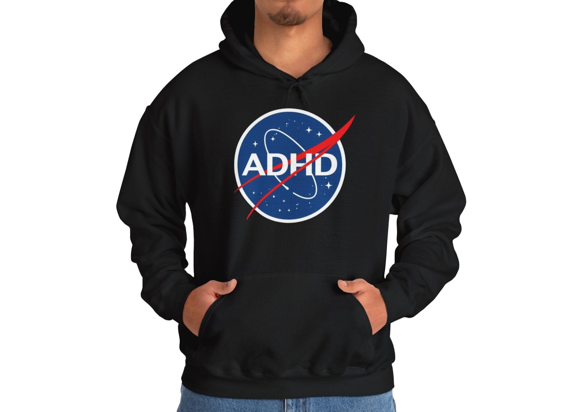 Model wearing a black hoodie with a NASA-inspired logo and the word "ADHD," standing with hands in pockets. Part of the Vivid Divergence Sensory Friendly Unisex Hoodie Range.