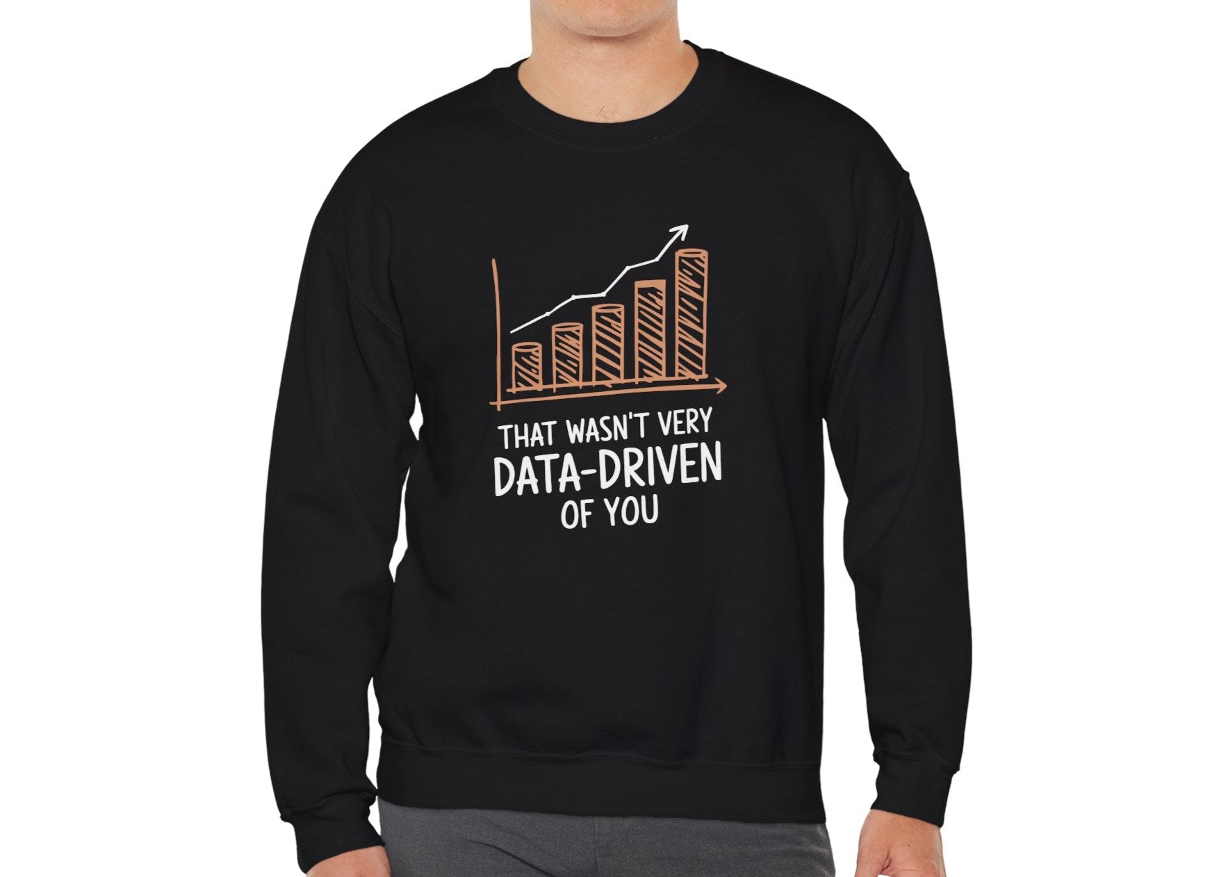 Model wearing a black sweatshirt with a rising bar graph illustration and the text "That Wasn't Very Data-Driven of You," standing with hands at sides. Part of the Vivid Divergence Sensory Friendly Unisex Sweater Jumper Range.