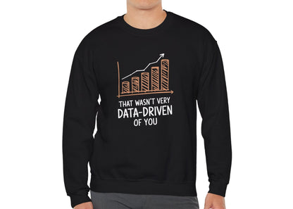 Model wearing a black sweatshirt with a rising bar graph illustration and the text "That Wasn't Very Data-Driven of You," standing with hands at sides. Part of the Vivid Divergence Sensory Friendly Unisex Sweater Jumper Range.