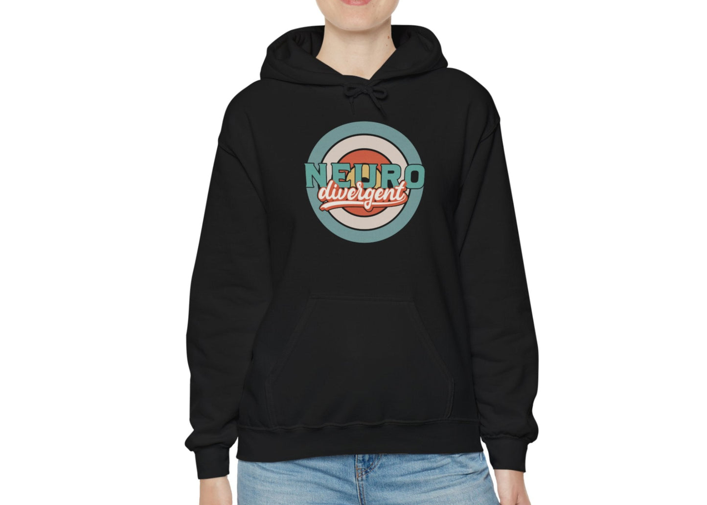 Model wearing a black hoodie with a retro-style circular target design and the word "Neurodivergent," standing with hands in pockets. Part of the Vivid Divergence Sensory Friendly Unisex Hoodie Range.