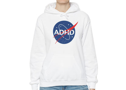 Model wearing a white hoodie with a NASA-inspired logo and the word "ADHD," standing with hands at sides. Part of the Vivid Divergence Sensory Friendly Unisex Hoodie Range.
