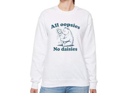 Model wearing a white sweatshirt with a cartoon bear holding a sunflower and the text "All Oopsies, No Daisies," standing with hands at sides. Part of the Vivid Divergence Sensory Friendly Unisex Sweater Jumper Range.