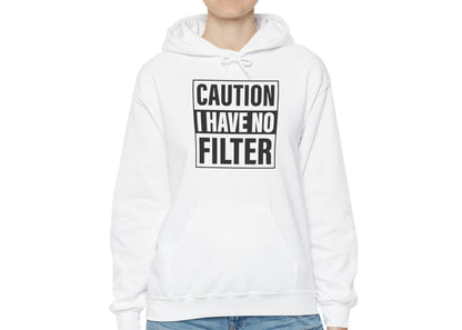 Model wearing a white hoodie with bold black text inside a rectangular border that reads "Caution: I Have No Filter," standing with hands at sides. Part of the Vivid Divergence Sensory Friendly Unisex Hoodie Range.