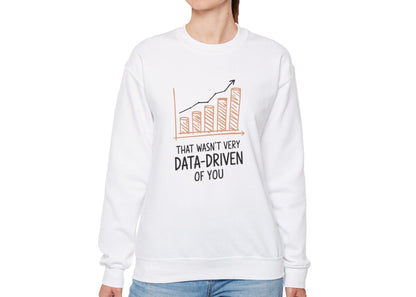 Model wearing a white sweatshirt with a rising bar graph illustration and the text "That Wasn't Very Data-Driven of You," standing with hands at sides. Part of the Vivid Divergence Sensory Friendly Unisex Sweater Jumper Range.