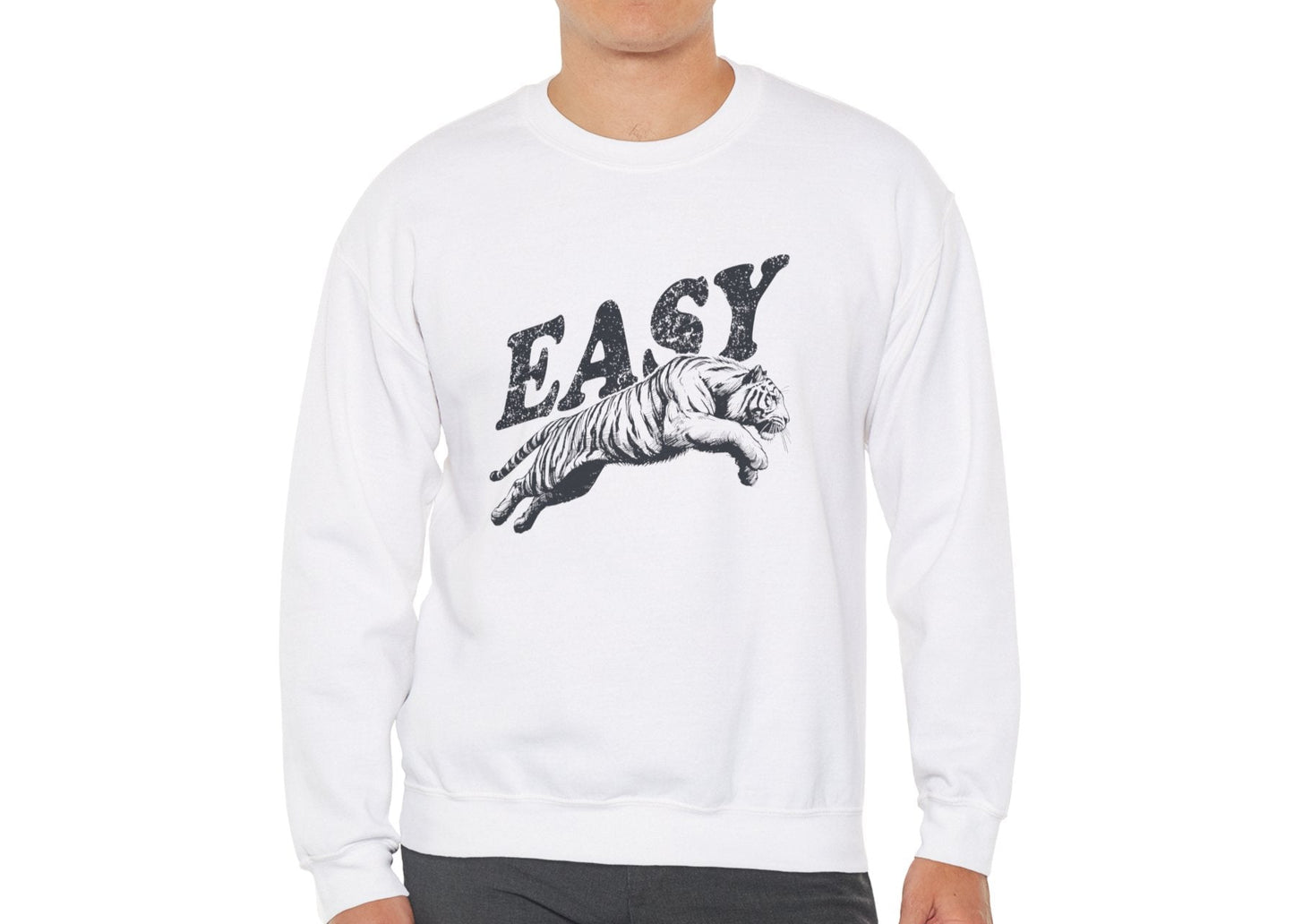 Model wearing a white sweatshirt with "EASY" in black letters and a leaping tiger graphic, standing with hands at sides. Part of the Vivid Divergence Sensory Friendly Unisex Sweater Jumper Range.