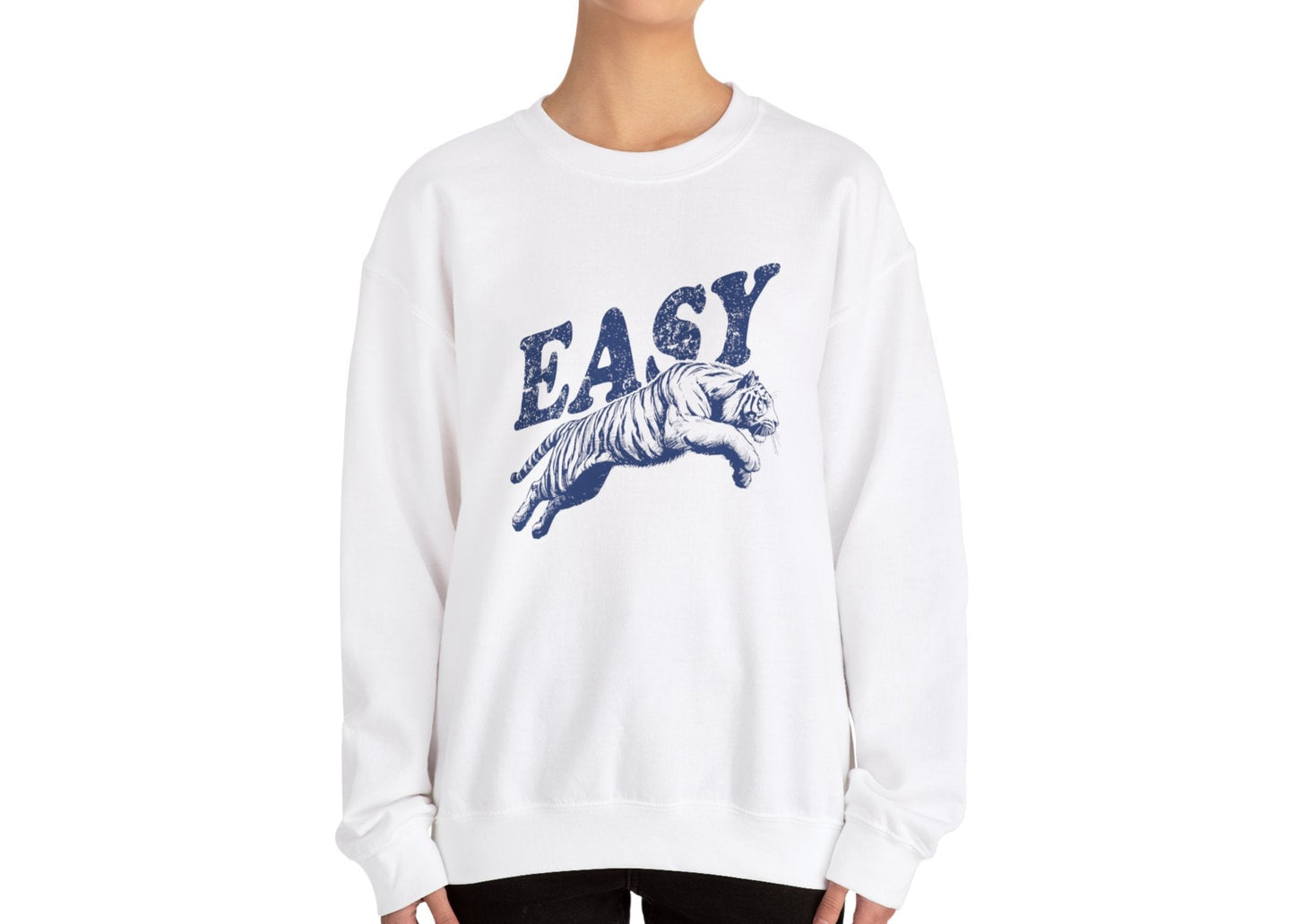 Model wearing a white sweatshirt with "EASY" in blue letters and a leaping tiger graphic, standing with hands at sides. Part of the Vivid Divergence Sensory Friendly Unisex Sweater Jumper Range.