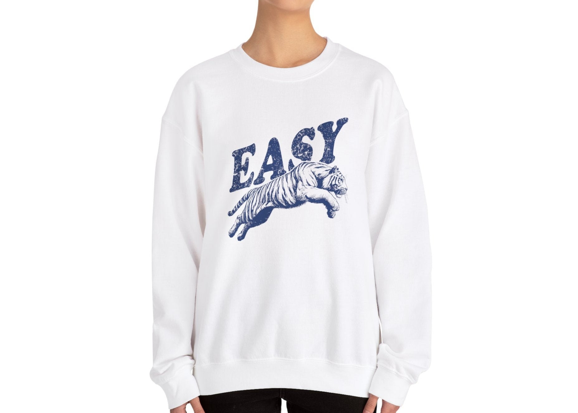 Model wearing a white sweatshirt with "EASY" in blue letters and a leaping tiger graphic, standing with hands at sides. Part of the Vivid Divergence Sensory Friendly Unisex Sweater Jumper Range.
