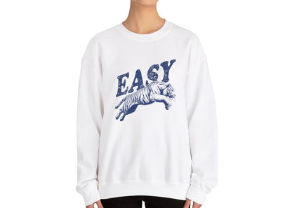 Model wearing a white sweatshirt with "EASY" in blue letters and a leaping tiger graphic, standing with hands at sides. Part of the Vivid Divergence Sensory Friendly Unisex Sweater Jumper Range.