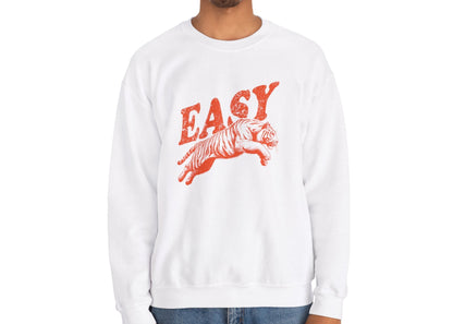 Model wearing a white sweatshirt with "EASY" in orange letters and a leaping tiger graphic, standing with hands at sides. Part of the Vivid Divergence Sensory Friendly Unisex Sweater Jumper Range.