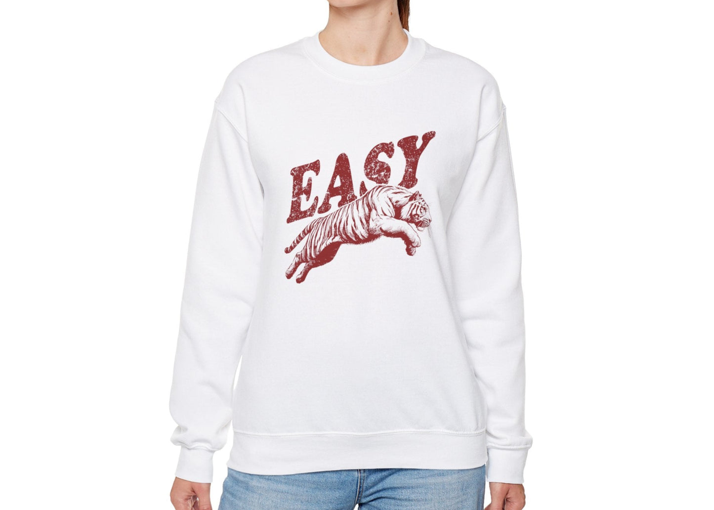 Model wearing a white sweatshirt with "EASY" in red letters and a leaping tiger graphic, standing with hands at sides. Part of the Vivid Divergence Sensory Friendly Unisex Sweater Jumper Range.